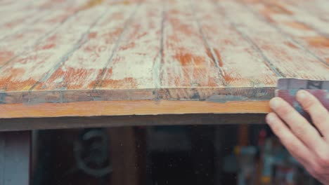 Hand-sanding-edge-of-wooden-boat-wheelhouse-cabin-planks-CLOSE-UP
