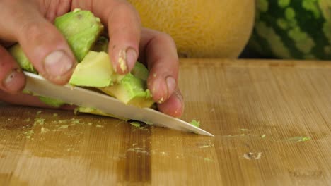 Sliced-Avocado-chunks-are-picked-up-with-the-use-of-a-knife-after-chopping