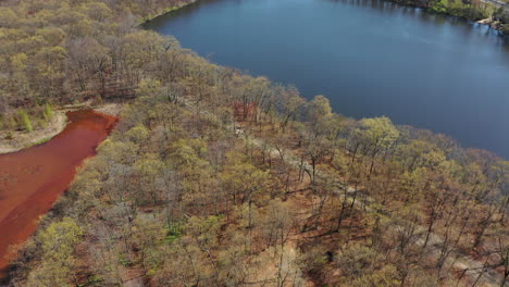 An-aerial-view-of-a-orange-colored-lake-during-the-day