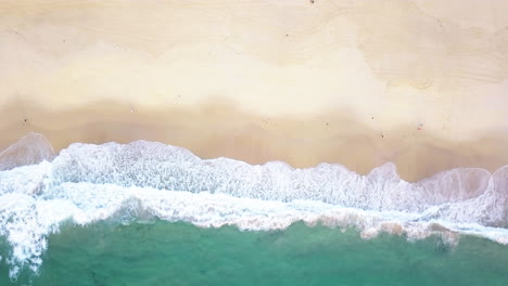 Foamy-Ocean-Waves-Splashing-On-The-Sand---Bondi-Beach-In-Sydney,-Australia---top-down-drone,-slow-motion
