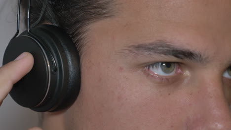 An-inspired-Youngman-with-headphones-enjoying-music-in-a-close-up-view