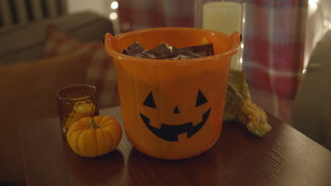 Close-Up-Pan-of-a-Halloween-Pail-Filled-with-Candy