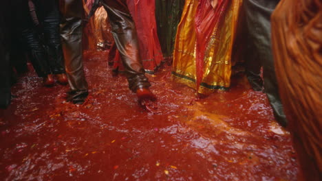 People-walk-around-in-a-large-puddle-of-colored-water