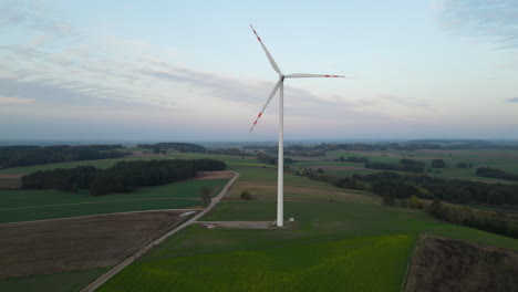 Scenic-Meadow-Landscape-With-Slowly-Rotating-Propeller-Of-Wind-Turbines-In-Lubawa,-Poland