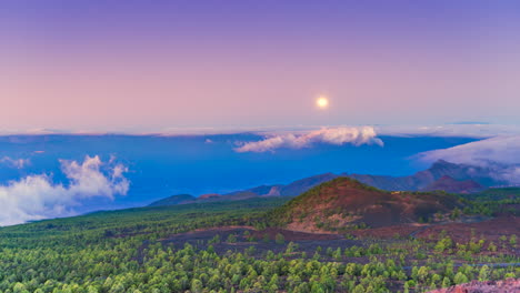 Timelapse-of-the-moon-falling-behind-the-horizon-during-sunrise-in-the-volcanic-mountains-of-the-island-of-Tenerife,-Canary-Islands,-Spain