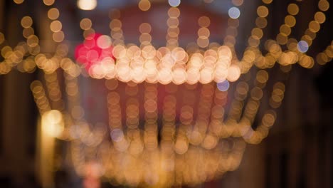 Yellow-blurred-Christmas-lights-rows-with-flickering-white-and-red-lights