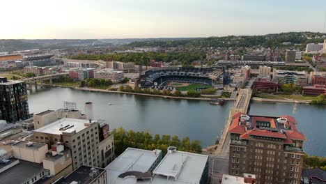Gorgeous-aerial-reveals-PNC-Park-baseball-and-Heinz-Field-football-stadiums-and-bridges-over-rivers-in-Pittsburgh,-PA,-USA