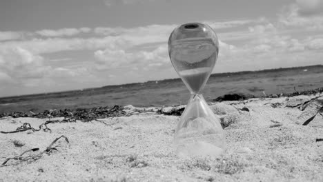 hour-glas-on-the-beach-black-and-white
