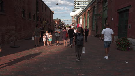 Wide-shot-of-people-on-one-of-the-cobblestone-promenades-in-Toronto's-Distillery-District
