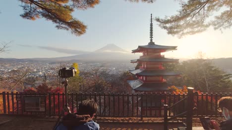 Photographer-and-tourists-at-famous-Chureito-Pagoda-near-Mt-Fuji,-Japan-during-sunset