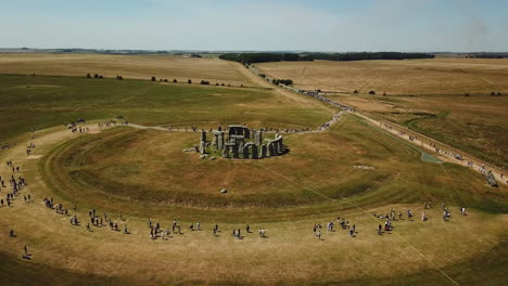 Amazing-Stonehenge-ancient-stone-circle-in-UK,-aerial-arc-shot