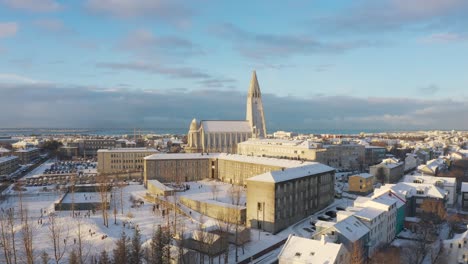 Aerial-Drone-Over-Snow-covered-Hallgrimskirkja-Church,-cathedral-In-View-In-Reykjavik,-Iceland
