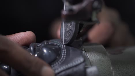 Closeup-Of-Sweatshop-Worker-Sewing-Leather-Sporting-Gloves,-Clothing-Industry-Manufacturing
