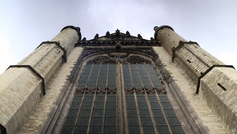 Bottom-up-timelapse-shot-of-old-town-Marekerk-Church-in-Leiden-City-during-cloudy-da,Netherlands
