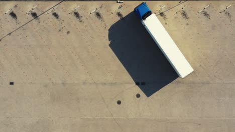 Aerial-view-of-a-semi-trailers-trucks-standing-at-the-warehouse-ramps-for-load-unload-goods-in-the-logistics-park