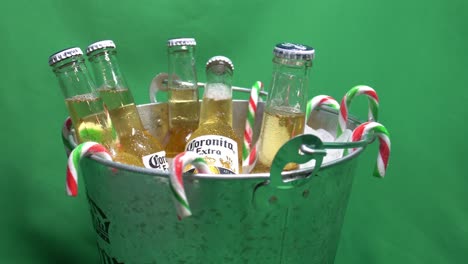 2-2-green-screen-christmas-candy-canes-hangining-in-corona-extra-metal-beer-bucket-filled-with-iced-and-a-6-pack-of-coronita-207-ml-rotating-ready-for-the-festive-party-pack-combo-thirst-quenching-fun