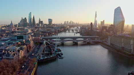 Establishing-Aerial-drone-dolly-forward-shot-of-thames-river-London-city-centre-sunrise