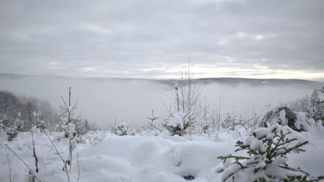 Heavy-fog-is-rolling-over-hills-in-beautiful-winter-landscape-time-lapse