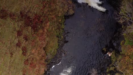 Aerial-Drone-top-down-flyover-of-Lealt-Fall-waterfall-in-Skye-Scotland-Autumn