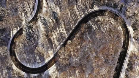 Timelapse-of-serpentine-driving-cars-at-a-winter-landscape-filmed-by-a-drone-and-a-look-up-shot-to-a-wonderful-white-monastery