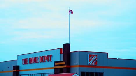 Home-Depot-Entrance-on-a-winday-twilight-sunset-early-afternoon-front-entrance-with-clear-skies-some-rolling-clouds-and-a-centered-Canadian-Flag