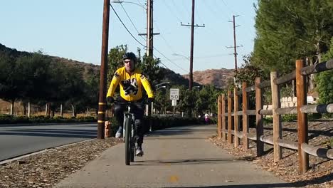 Single-male-bicyclist-on-bike-path,-early-cold-morning-in-slow-motion