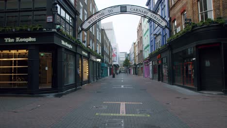 Lockdown-in-London,-slow-motion-gimbal-walk-along-completely-empty-Carnaby-Street,-Soho,-during-the-Coronavirus-pandemic