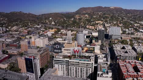 Aerial-orbital-shot-of-downtown-Hollywood-with-the-Hollywood-Sign-in-the-background
