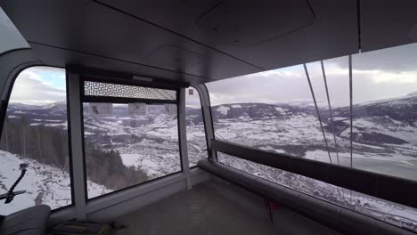 Wide-angle-view-of-the-inside-of-gondola-cabin-passing-huge-red-mast-on-the-way-down---Voss-gondolNorway
