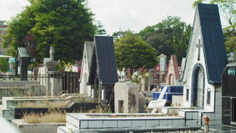 Pan-right-shot-of-graves-in-Christian-cemetery-during-day,-Medan