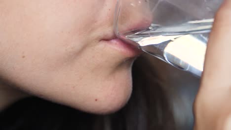 closeup-of-Healthy-young-female-holding-glass-drinking-fresh-transparent-pure-mineral-water,-woman-hydrating-thirst-with-drinking-water