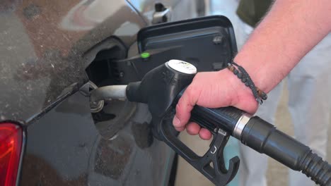 A-customer-refuels-his-car-with-diesel-oil-from-a-gas-pump-at-a-gas-station-in-Spain