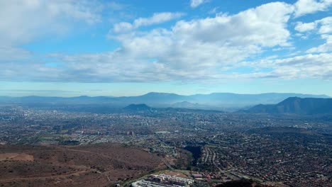 Aerial-view-dolly-in-of-the-Commune-of-Las-Condes,-Santiago,-Chile-on-a-clear-day-after-the-rain