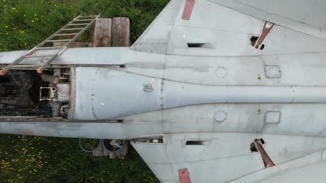Cockpit-aerial-view-above-distressed-neglected-Hawker-hunter-WT804-fighter-jet-on-British-pasture-farmland