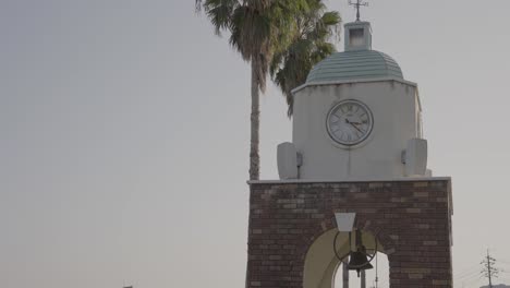 Bell-and-Clock-Tower-Ringing-in-Slow-Motion,-outdoor-warm-scene