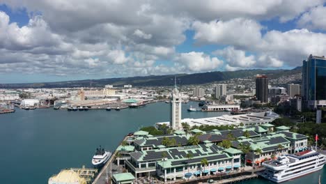 Wide-panning-aerial-shot-of-the-Aloha-Tower-in-the-Port-of-Honolulu-on-the-island-of-O'ahu,-Hawaii