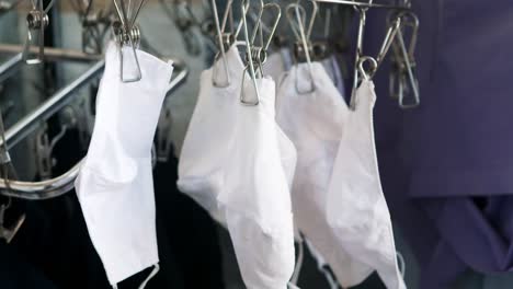 Selective-focus-of-washed-white-cloth-masks-to-dry-outdoors-after-a-week-of-anti-COVID-19-use