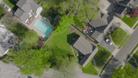 Overhead-view-with-scroll-up-of-suburban-neighborhood-houses-amongst-trees-in-the-spring