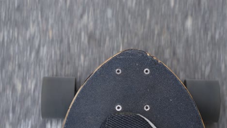 Longboard-skating-pov-on-newly-laid-asphalt-road