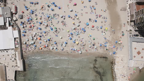 Aerial-overhead-static-hyperlapse-of-beach-goers-enjoying-the-sea-in-Bari,-Italy