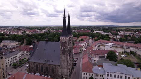rotating-around-st-Jakob-church-in-Kothen-in-Germany,-drone-shot