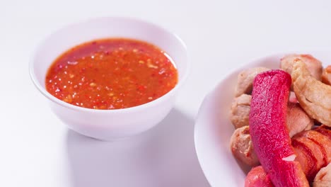 Fried-meatballs-and-dipping-sauce-on-a-white-background