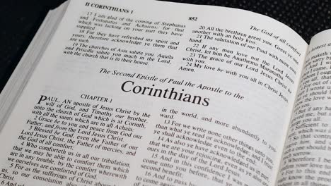 Close-Up-Shot-of-Bible-Page-Turning-to-the-book-of-Second-Corinthians