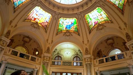 Handheld-tilt-up-of-the-internal-facade-and-stained-glass-windows-of-the-dome-of-the-Intendencia-de-Santiago,-current-presidential-delegation,-Santiago,-Chile