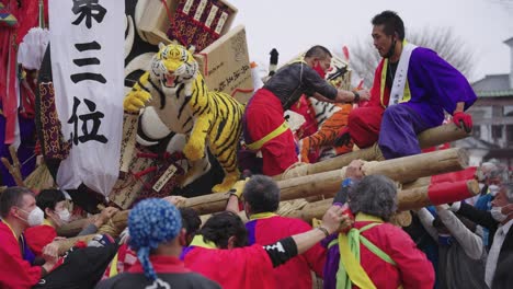 Festival-Battle-at-Year-of-the-Tiger-Sagicho,-Teams-Climb-over-Mikoshi-Floats