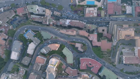 Static-aerial-overhead-top-down-footage-of-cars-driving-on-different-sections-of-a-hill-in-Naples,-Italy