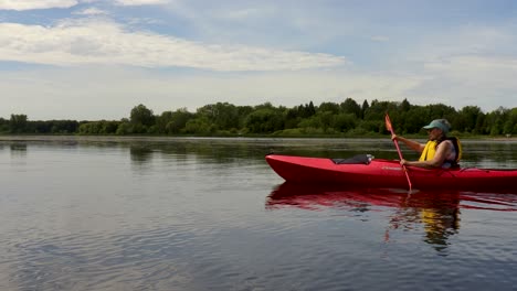 A-kayak-skims-along-the-calm-water-of-an-Ontario-conservation-area