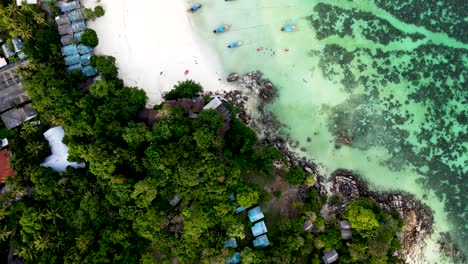 Beautiful-coral-reef-at-Pattaya-beach-at-Koh-Lipe-Island-Thailand-during-sunset,-aerial-tilt-and-reveal