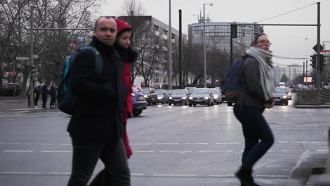 Shot-of-a-Landsberger-Allee-and-Storkower-Strasse,-people-crossing-in-Slow-Motion,-busy-street,-circa-2018