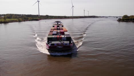 Petran-Container-Vessel-Cruising-On-The-Serene-Oude-Maas-River-In-The-Netherlands-With-View-Of-Modern-Windmills